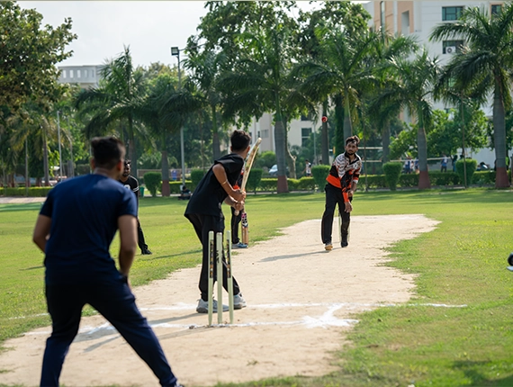 Students playing cricket on the KIET ground